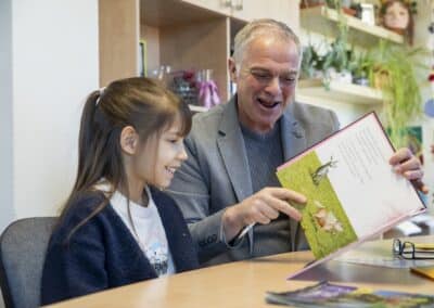 Primary children reading books in the library at Park Lane